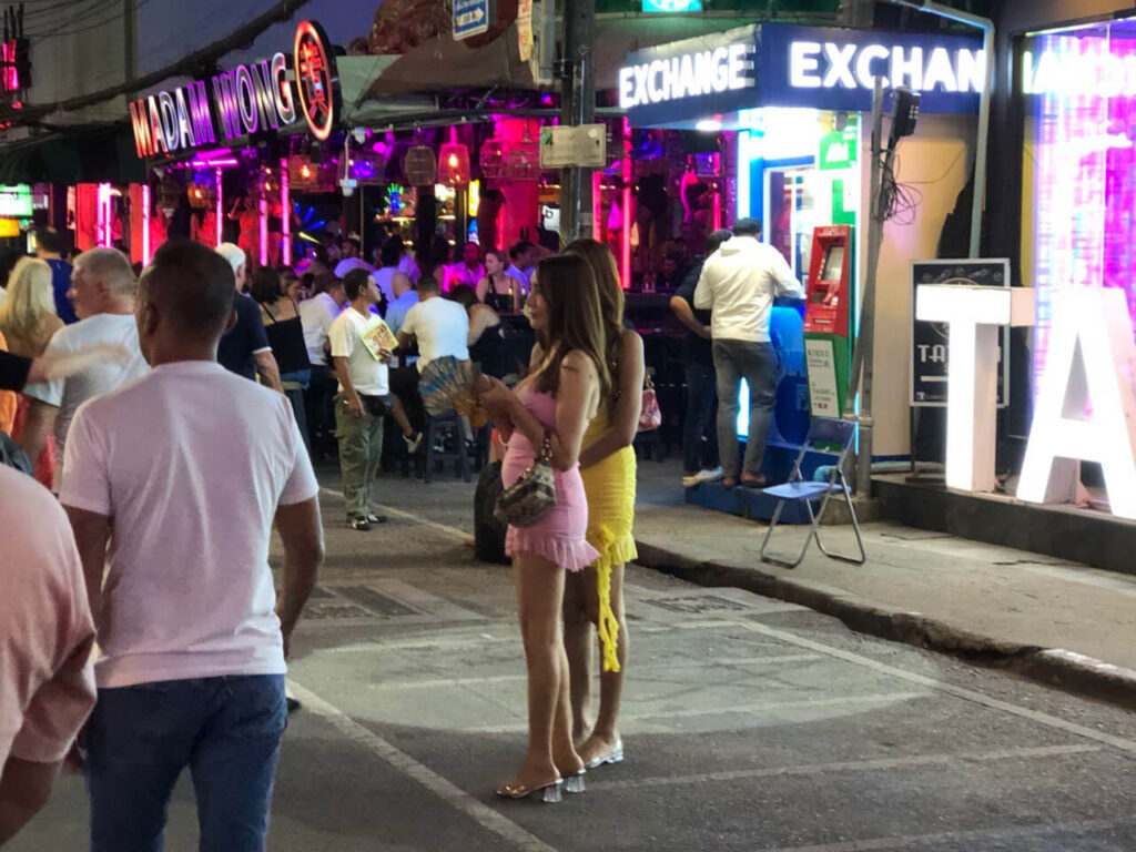 Thai freelancers standing along Bangla Road at night
