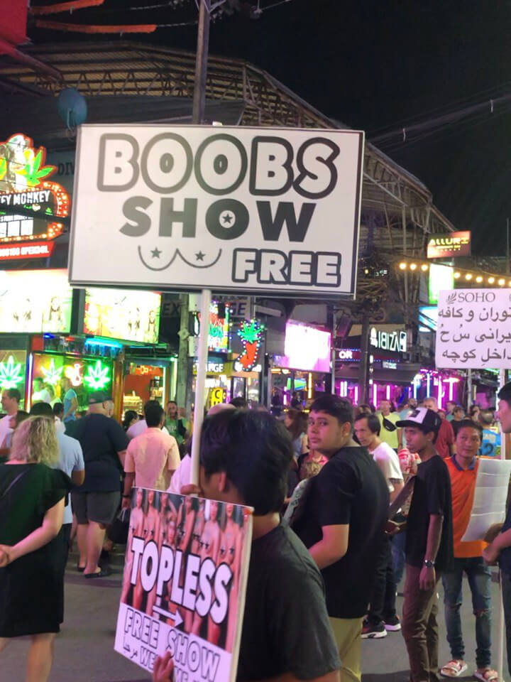 Promoter holding a sign for a free adult show on Bangla Road