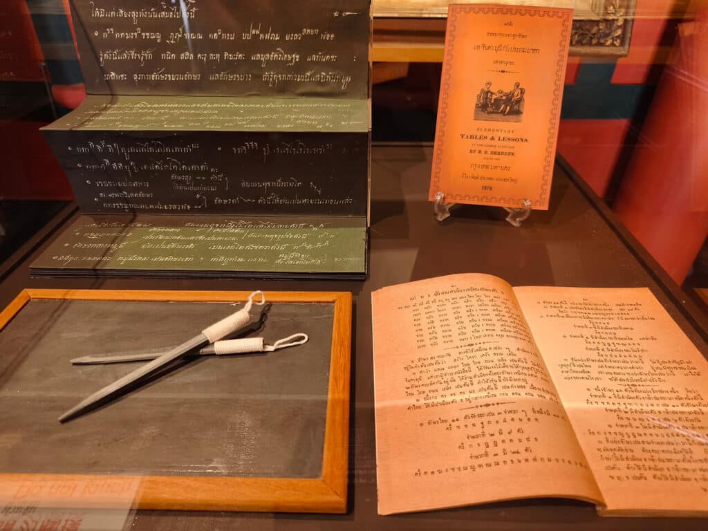 A slate board in a wooden frame and a manuscript for teaching spelling