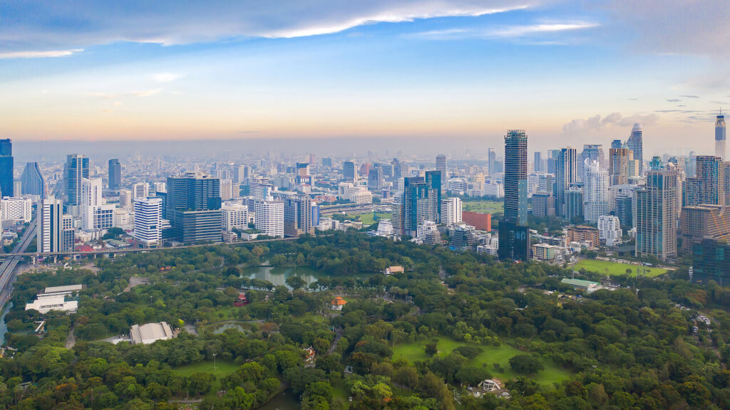 Aerial view of Lumphini Park in central Bangkok surrounded by skyscrapers