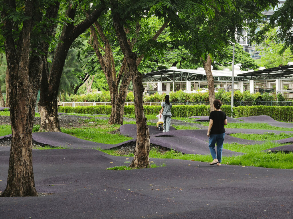 Area in Lumphini park with a cushioned surface where children can safely ride bicycles, scooters, or skateboards