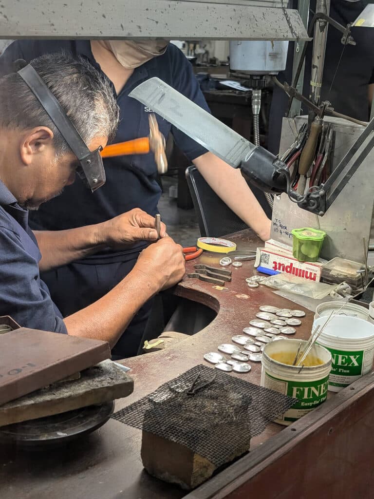 Craftsmen handmaking pewter products at the Royal Selangor factory